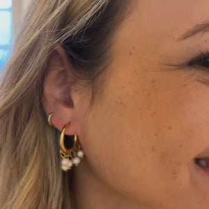 Perle Hoops Øreringe vist i bevægelse med fokus på ferskvandsperlerne og den gyldne finish.